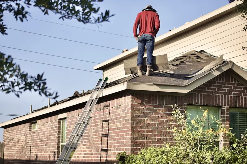 Professional roofer working on a residential roof in Pukalani